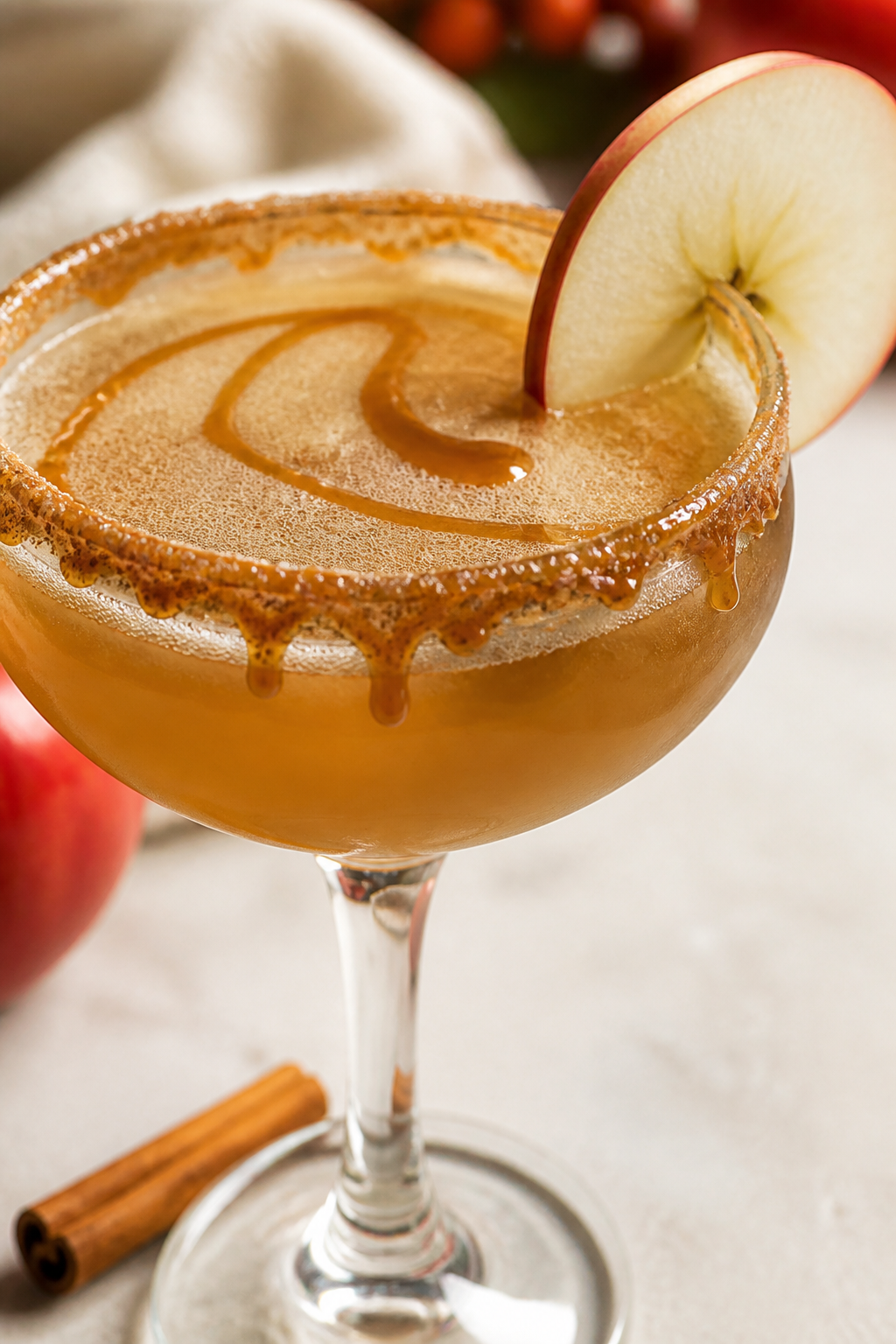 Close-up detail shot of the finished Caramel Apple Pie Cocktail “up”: a chilled coupe glass with