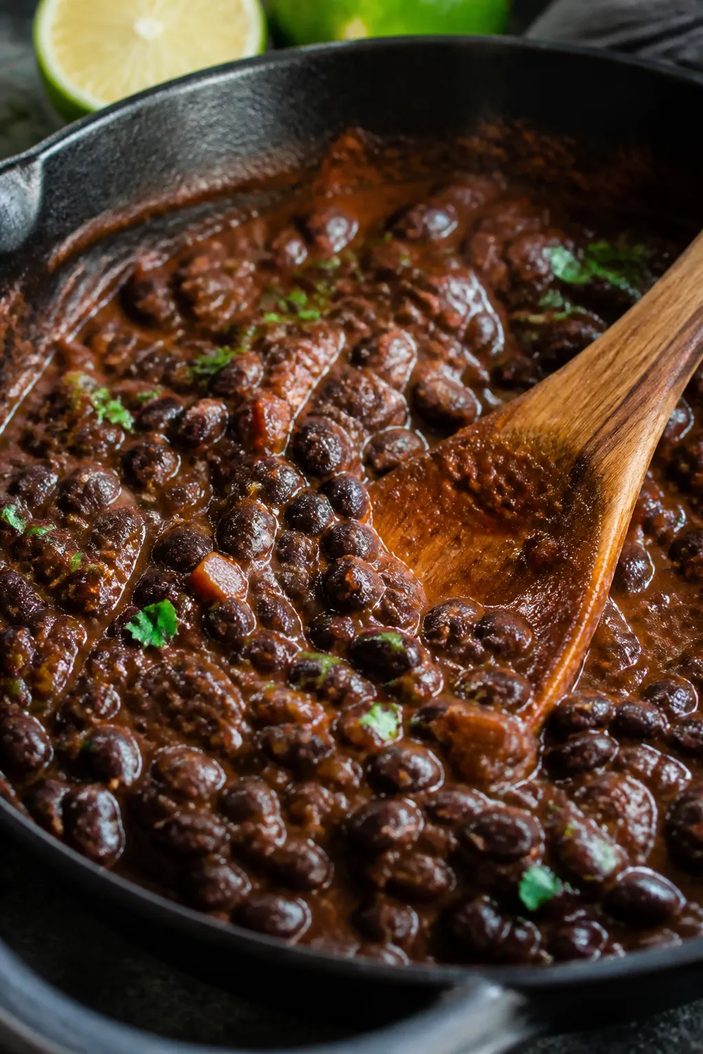 Cooking process close-up: A shallow depth-of-field macro shot of smoky black bean filling simmering 