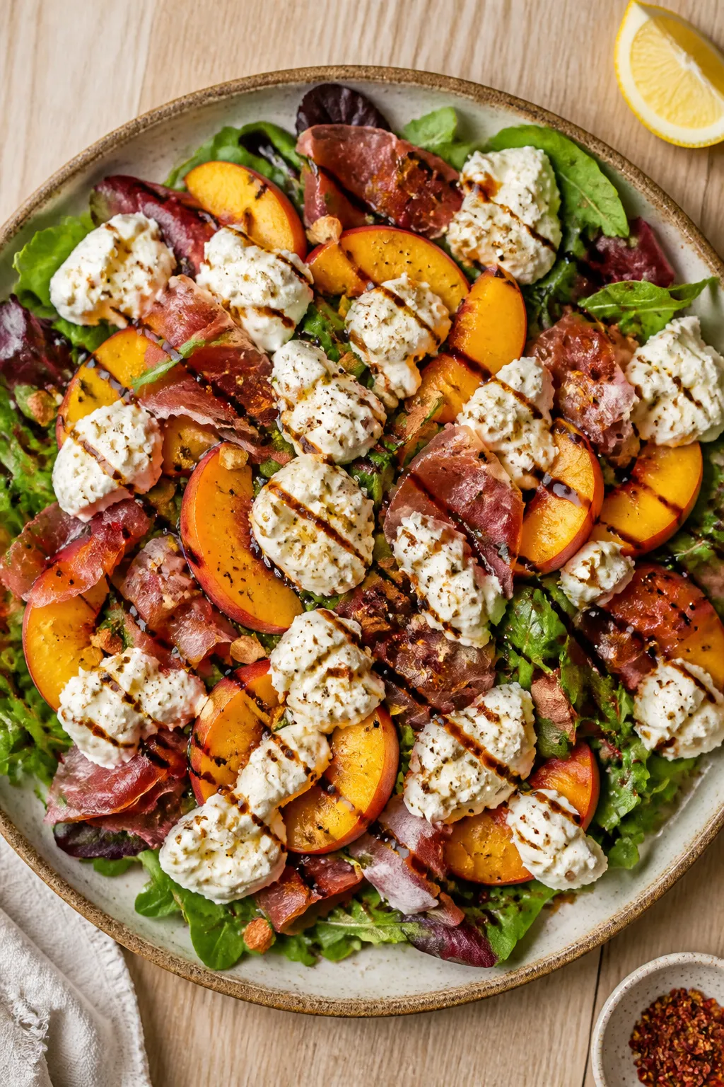 Overhead “tasty top view” of the final plated salad as a shareable platter: mixed tender greens 